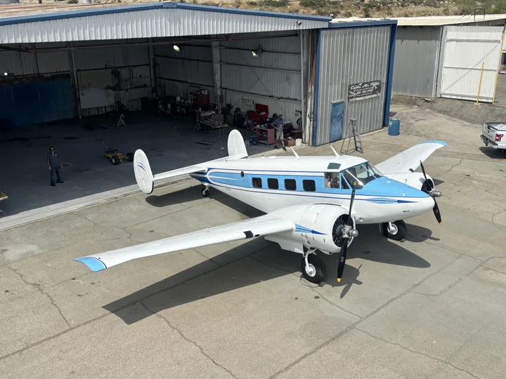 Front quarter view showing blue accents across the wings and fuselage
