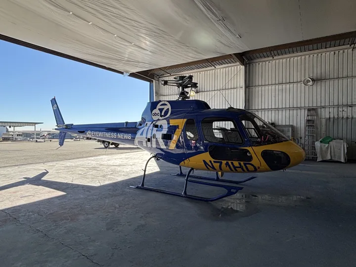 Blue and yellow helicopter paint scheme at the hangar