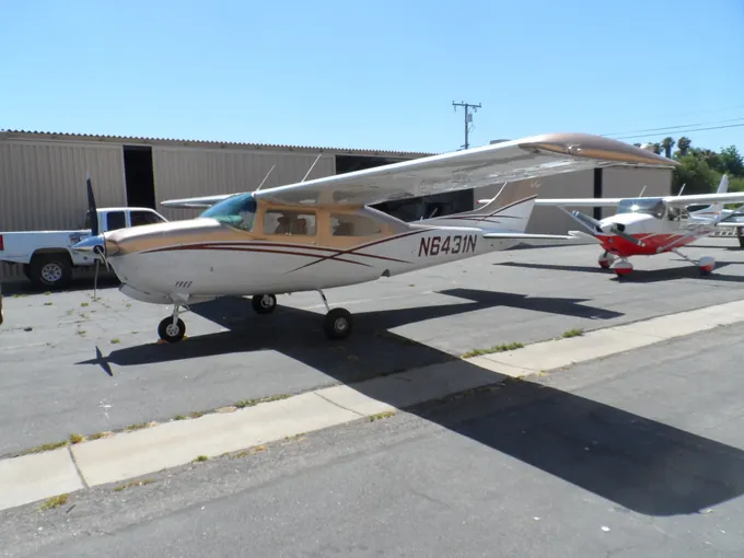 Tan-and-brown high-wing Cessna